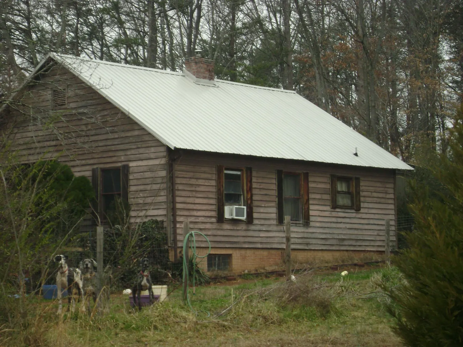White metal roof on an old wood sided farmhouse, from a Metal Roof Installation job in Atlantic City